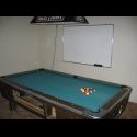 The pool table (marble slate) and the white board. Note the bar light above the table.