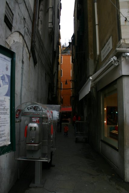 A narrow walkway and pay phones.