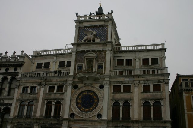 A complex clock.  The circle at the bottom is a 24 hour face with rotating hand around the edge.  In the middle is roman hours o