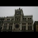 A complex clock.  The circle at the bottom is a 24 hour face with rotating hand around the edge.  In the middle is roman hours o