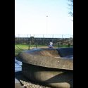 A fountain in a park.  Little boy in the background.