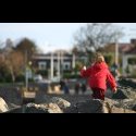 A little girl playing on the rocks.