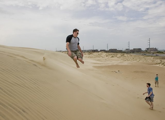 Deacon throwing himself down the sand dunes.