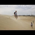 Deacon throwing himself down the sand dunes.