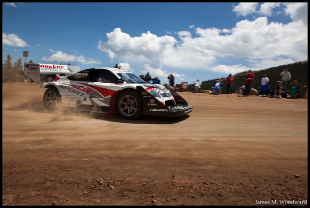 Monster's car, straightening out, kicking dirt hard. 